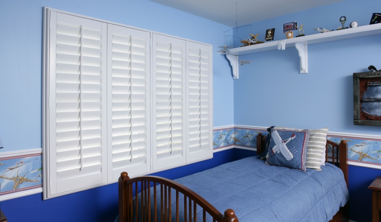 White plantation shutters in blue kids bedroom in Honolulu 